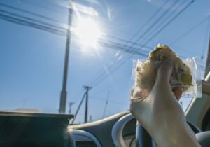 車の中で、おにぎりを食べる